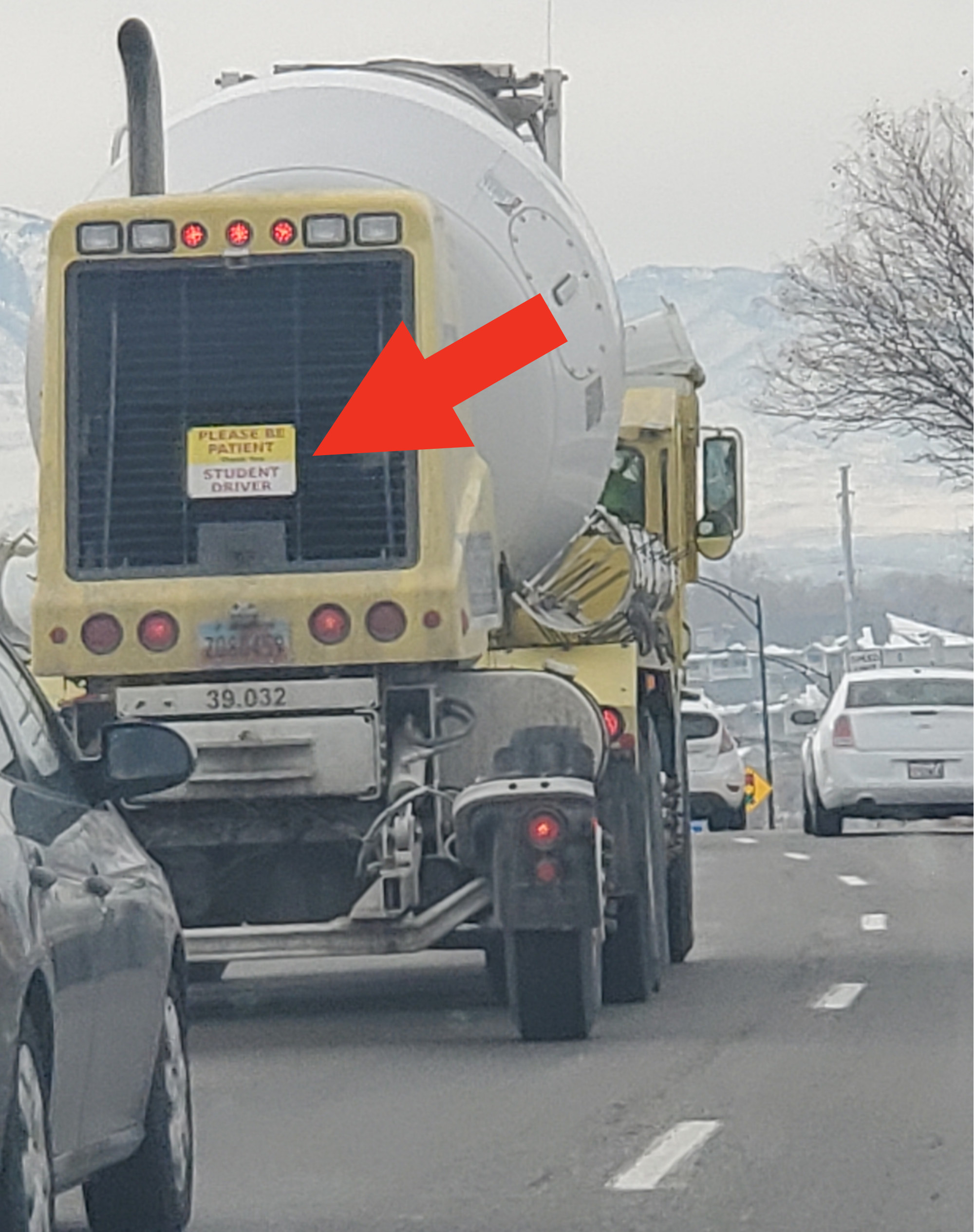 &quot;Please be patient, student driver&quot; sign on the back of a huge truck