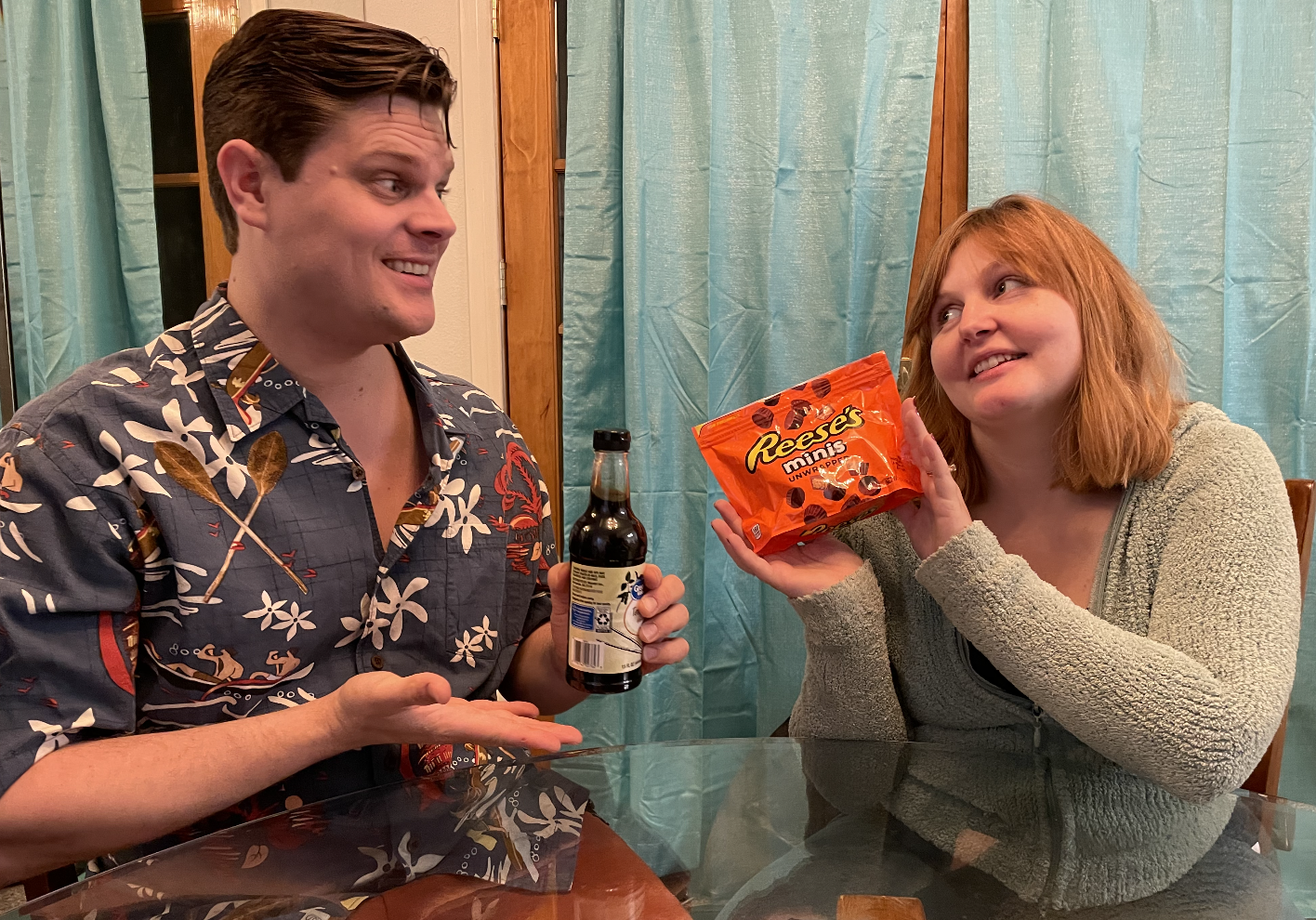 author and zach holding up a bag of reeses minis and a bottle of soy sauce
