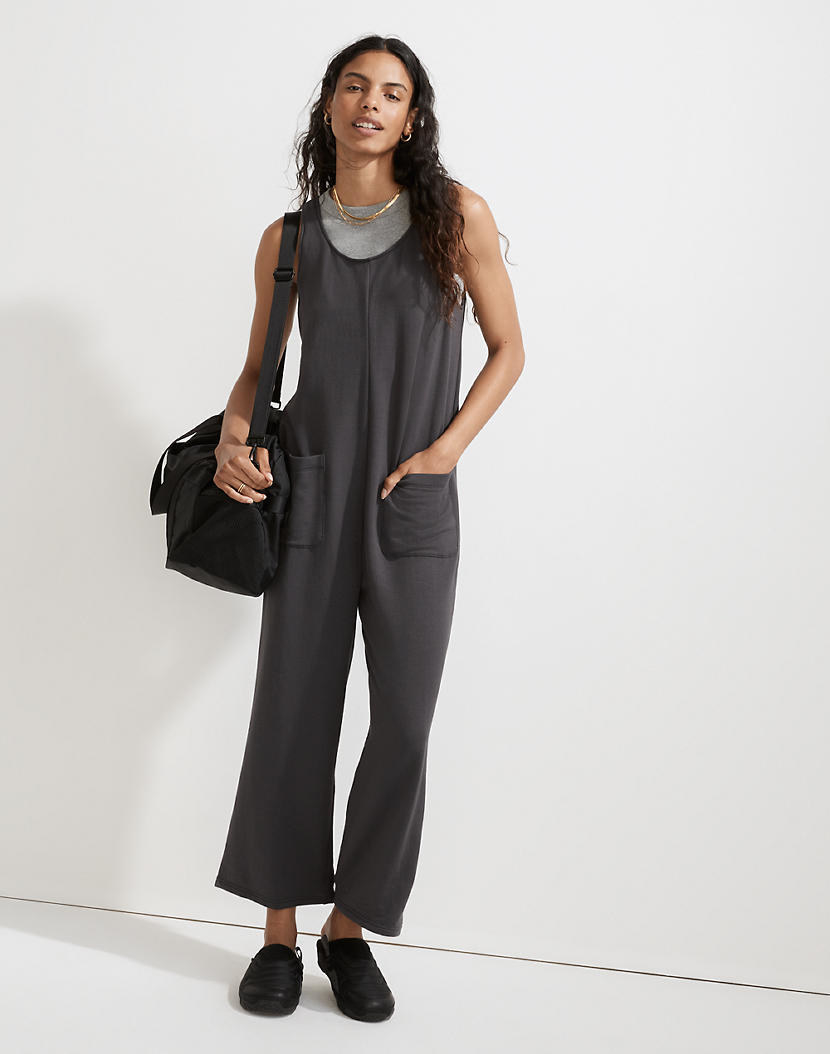 Model wearing charcoal grey short-sleeved jumpsuit with pockets