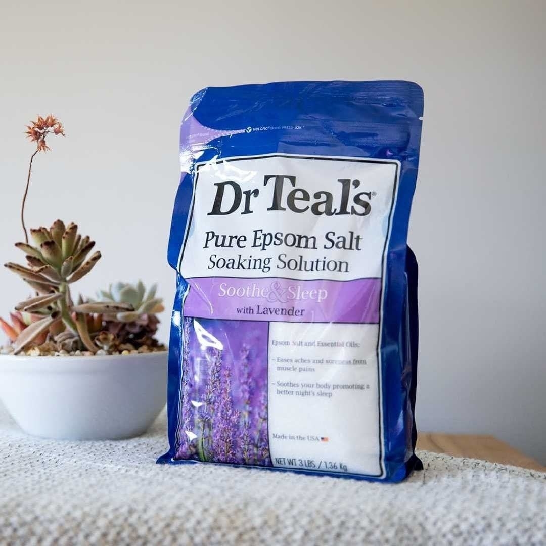 a pack of dr treal&#x27;s epsom salt soaking solution on a cozy surface next to a succulent