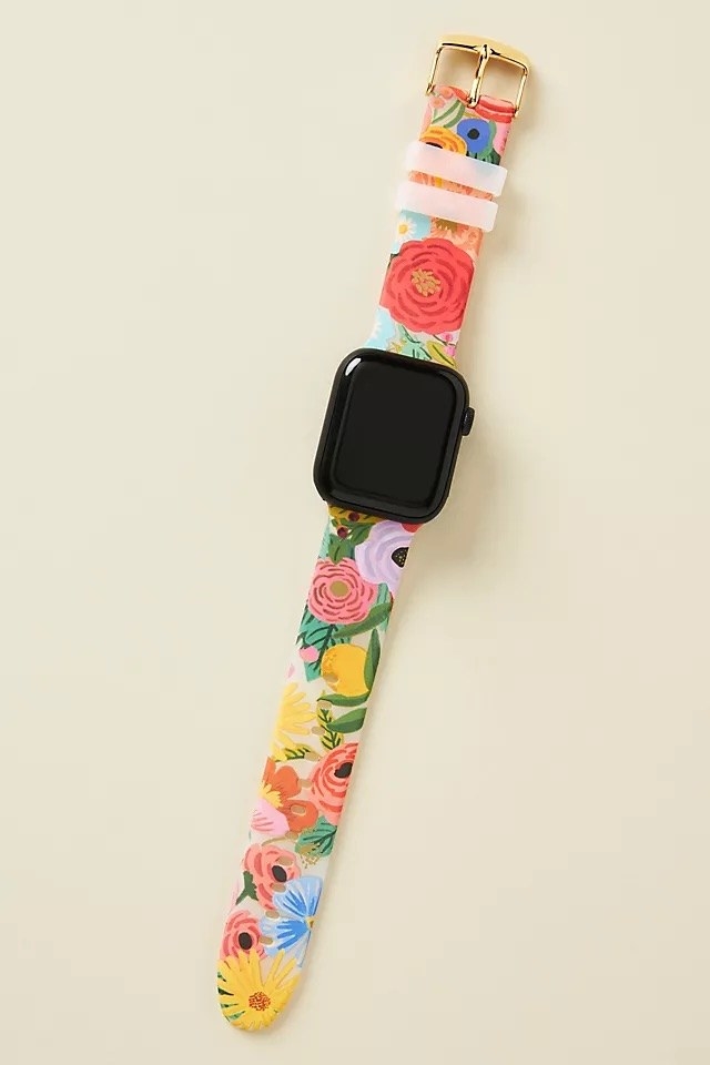 the colourful band on an Apple watch against a plain background