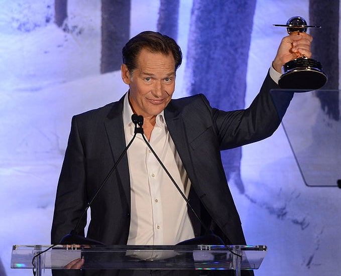 James Remar holding an award