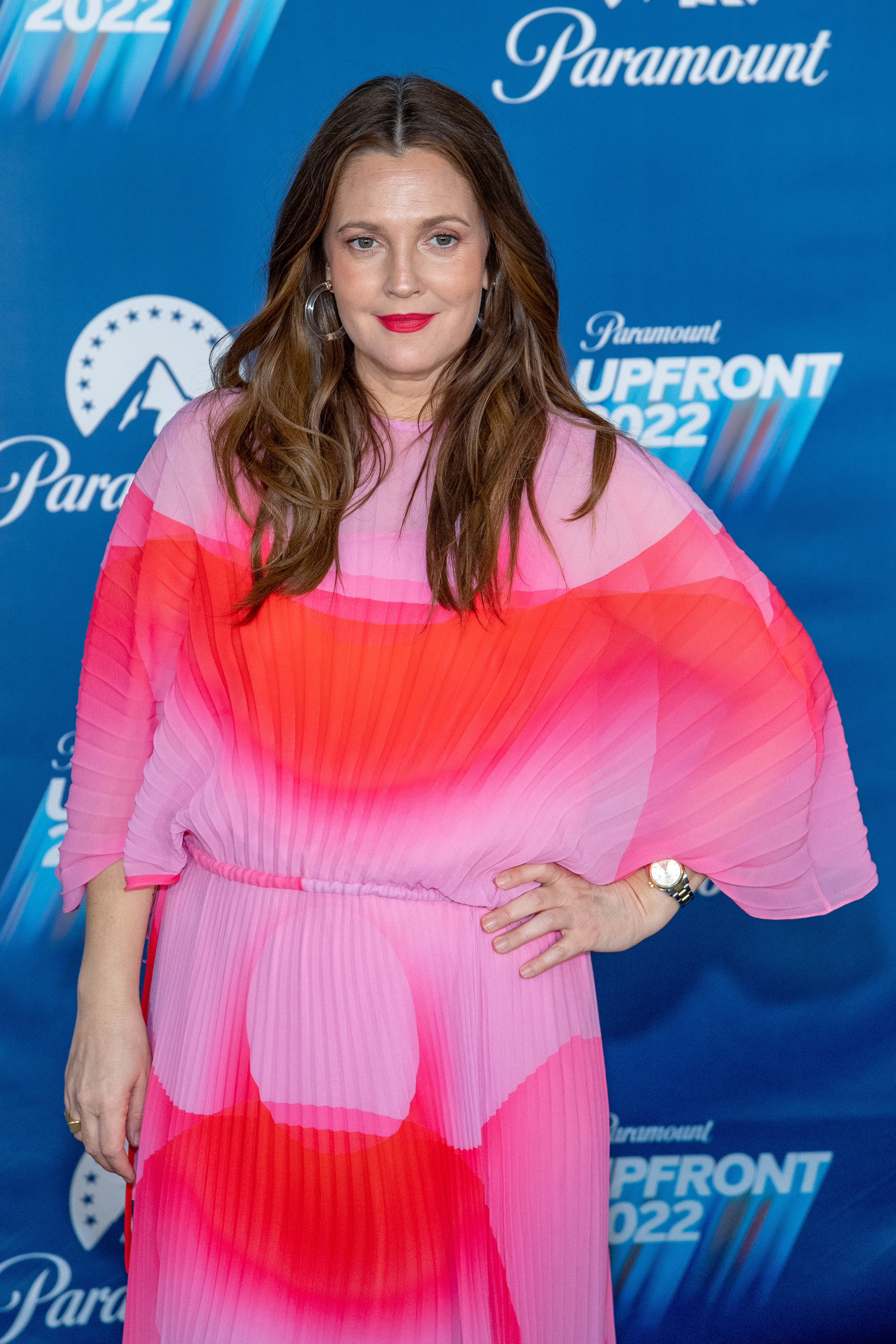 Drew with her hand hand on hip as she poses for photos at a red carpet event