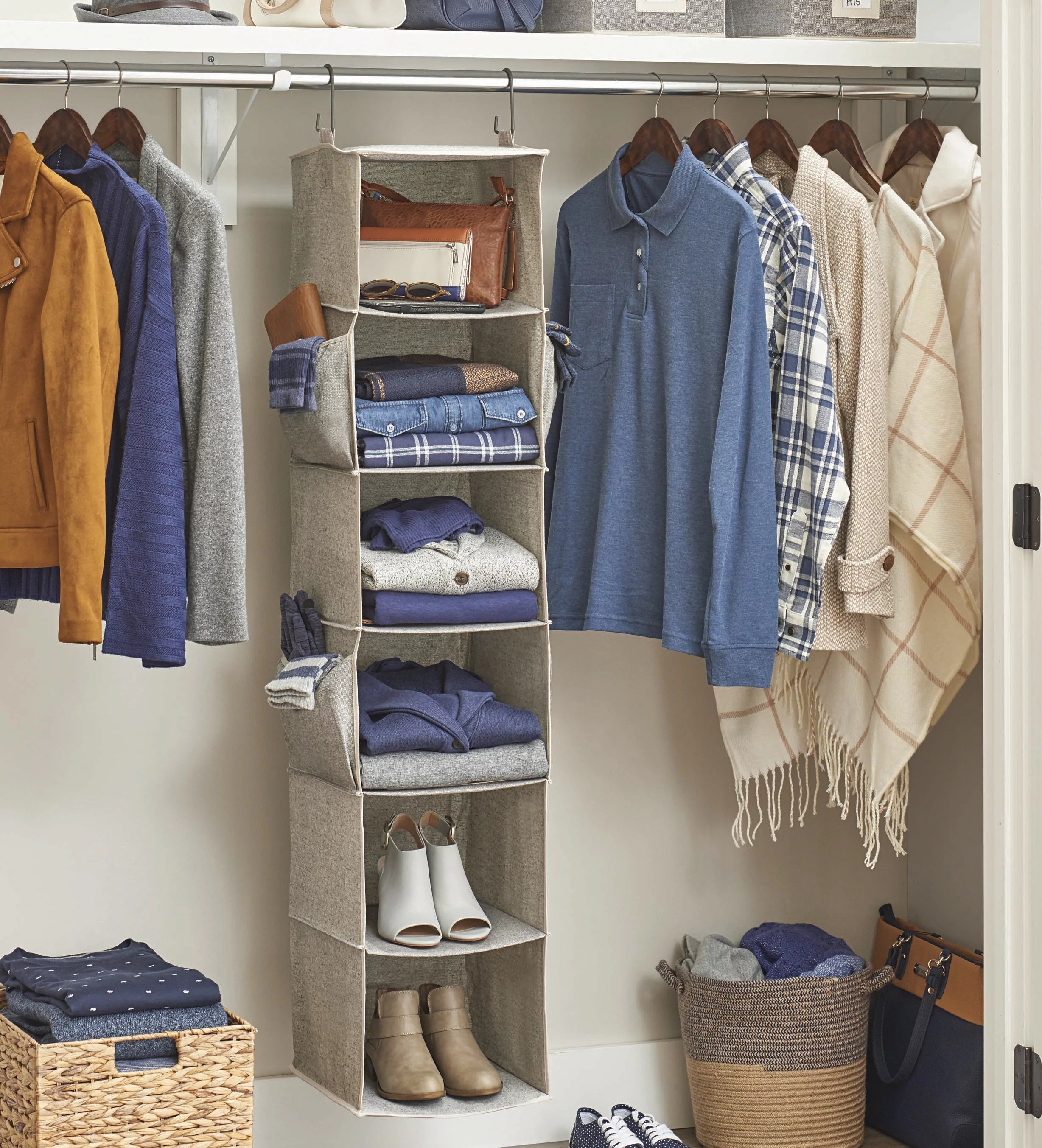 the beige closet organizer with clothes, shoes and accessories inside