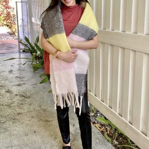 A reviewer wearing a blanket scarf