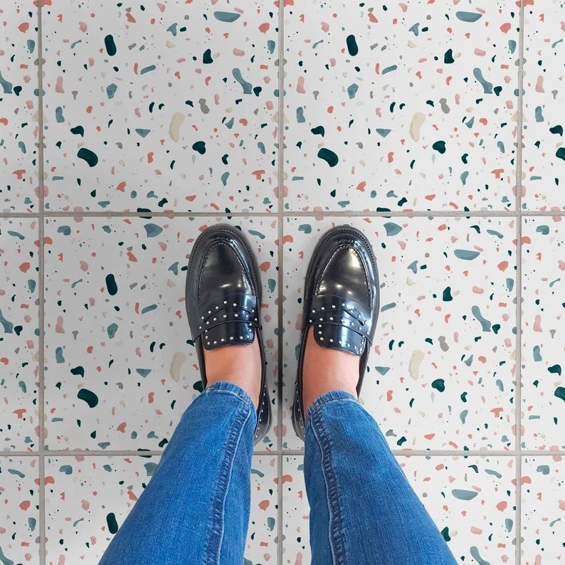 a person standing on a terrazzo tiled floor