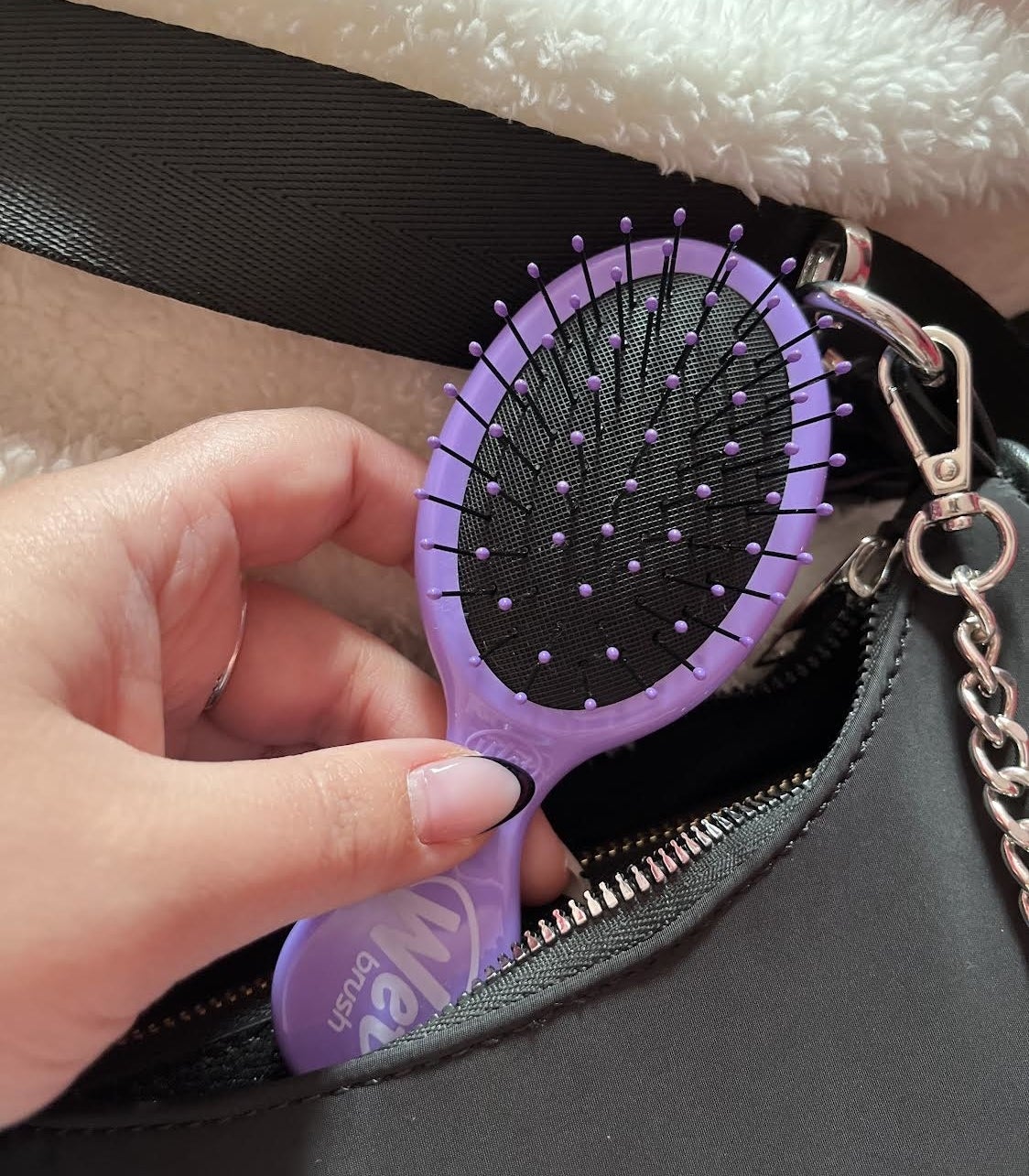 Bianca pulling the mini brush out of her purse