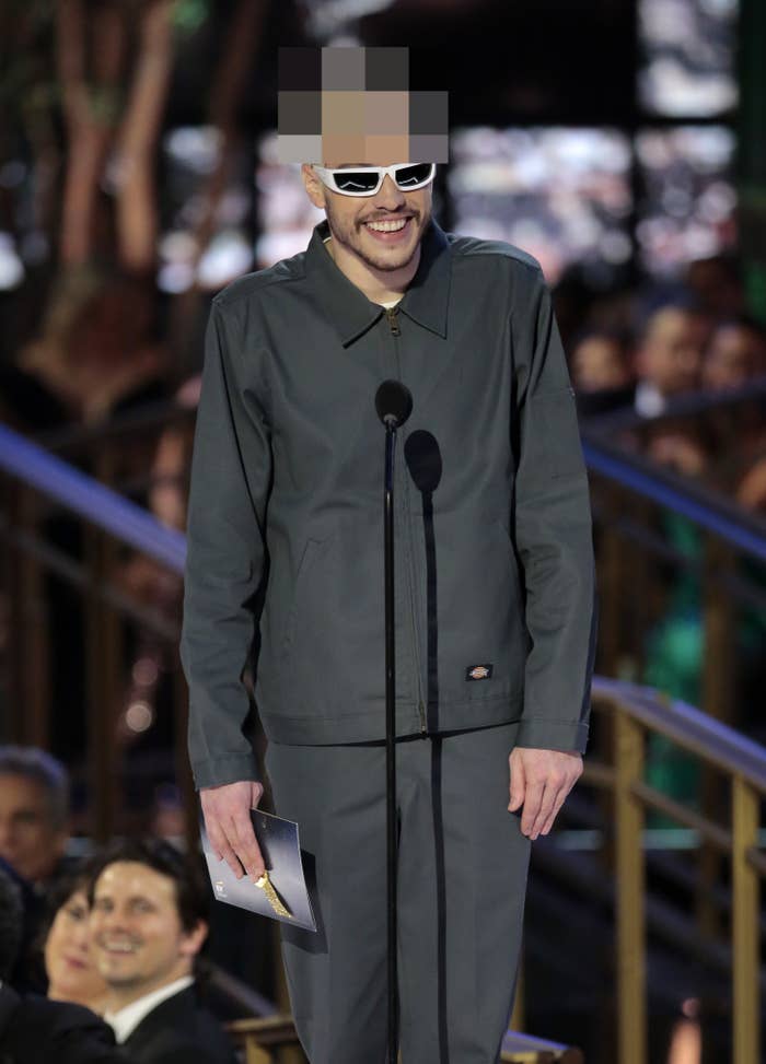 Pete standing onstage to present an award. His hair has been pixalated