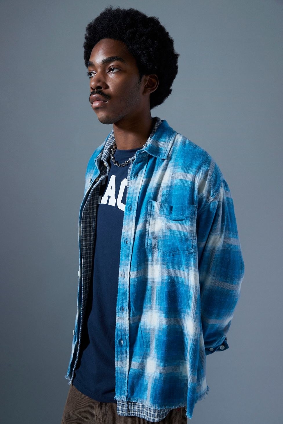 model in bright blue and white flannel button-up
