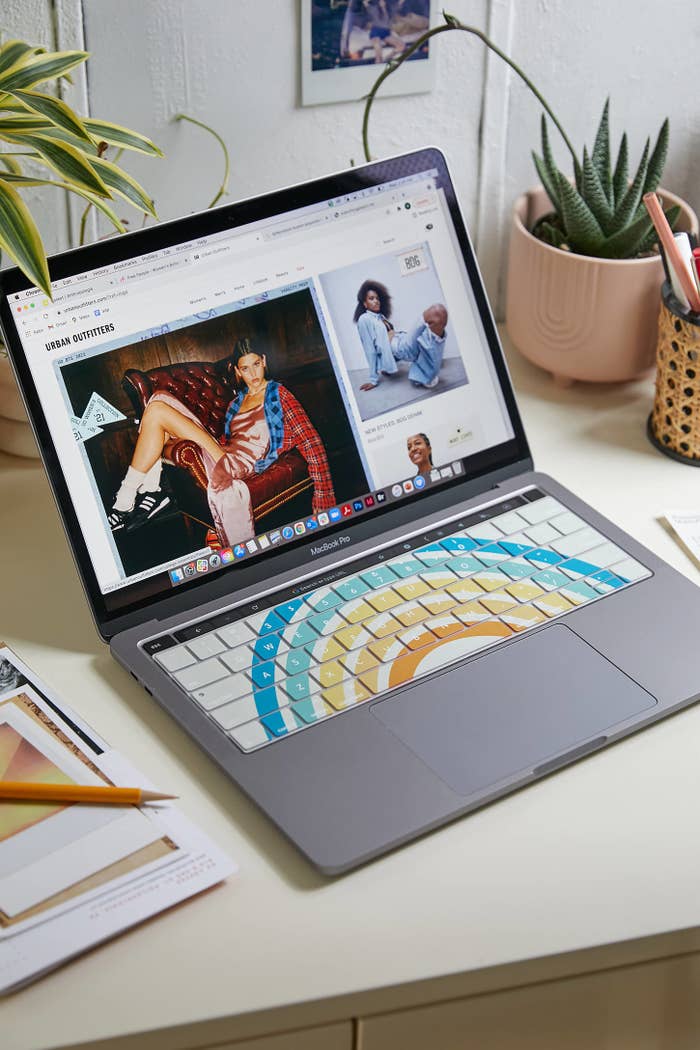 a laptop with a funky patterned keyboard cover on its keyboard