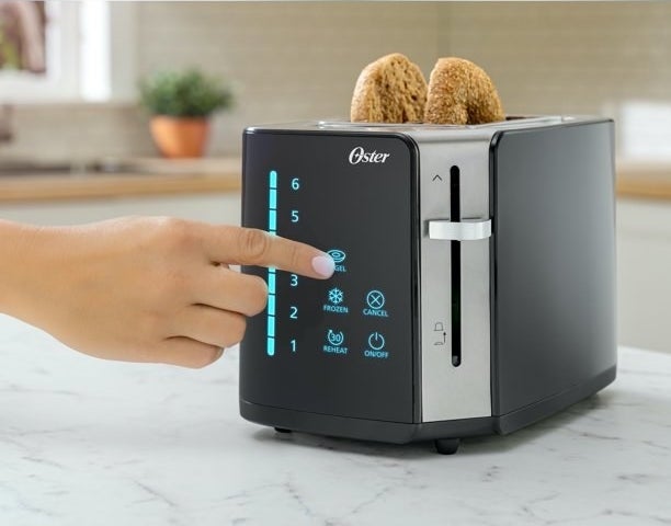a black toaster with a blue LED screen toasting a bagel