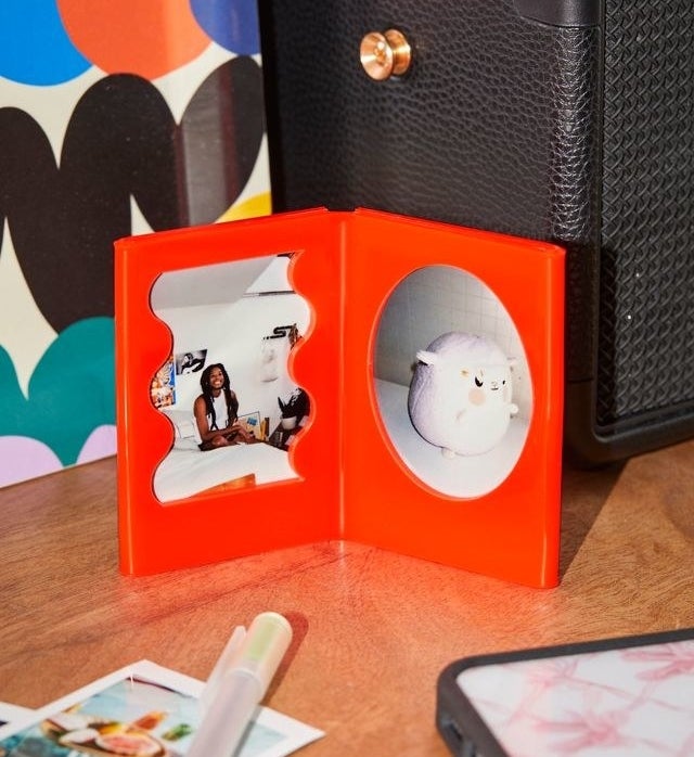 a small picture frame with two instax mini photos displayed in it