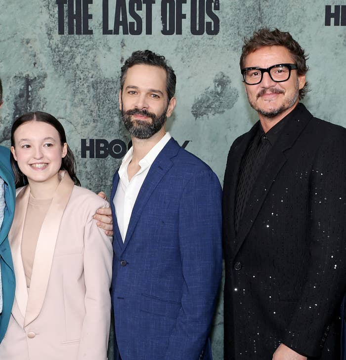 From left to right: Bella Ramsey, Neil, and Pedro Pascal on the red carpet