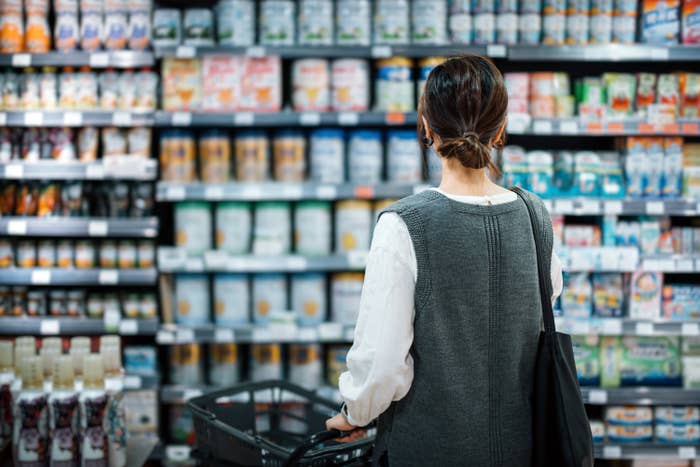 the back of a woman in a grocery store