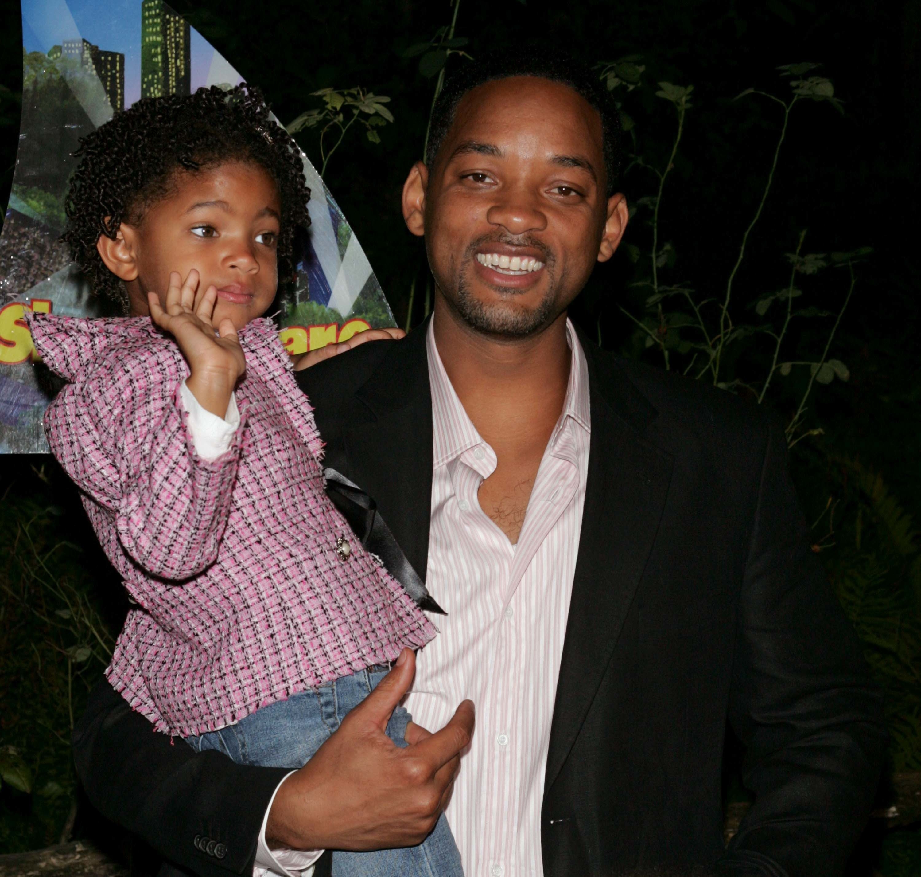 Will Smith holding daughter Willow in 2004 as she waves