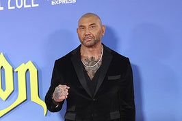 Dave wearing a velvet suit and silver chain necklace on the red carpet