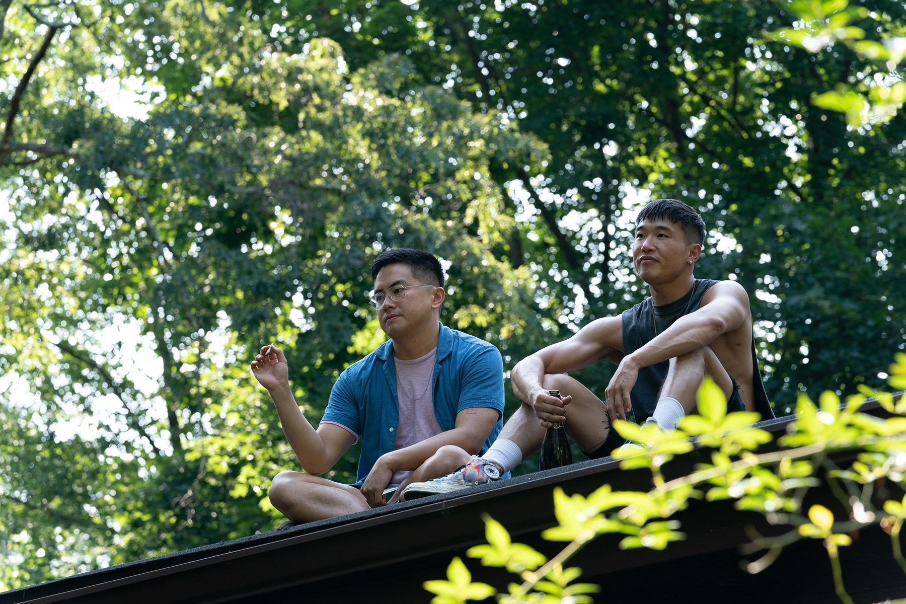 Bowen and Joel Kim Booster sitting on a roof
