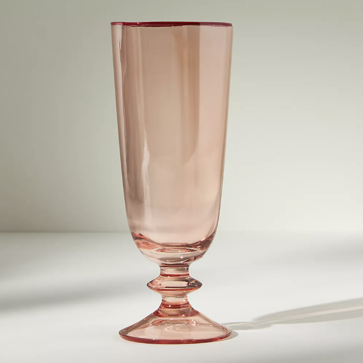 the champagne flute in front of a plain backdrop