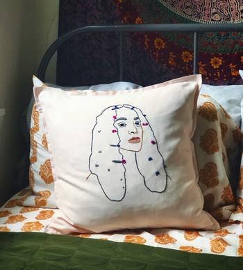 A pink pillow case embroidered with Solange's album cover