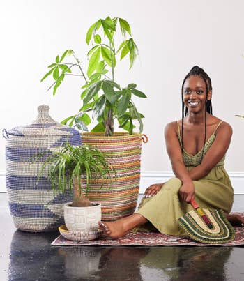 a model posing with multiple woven baskets and planters
