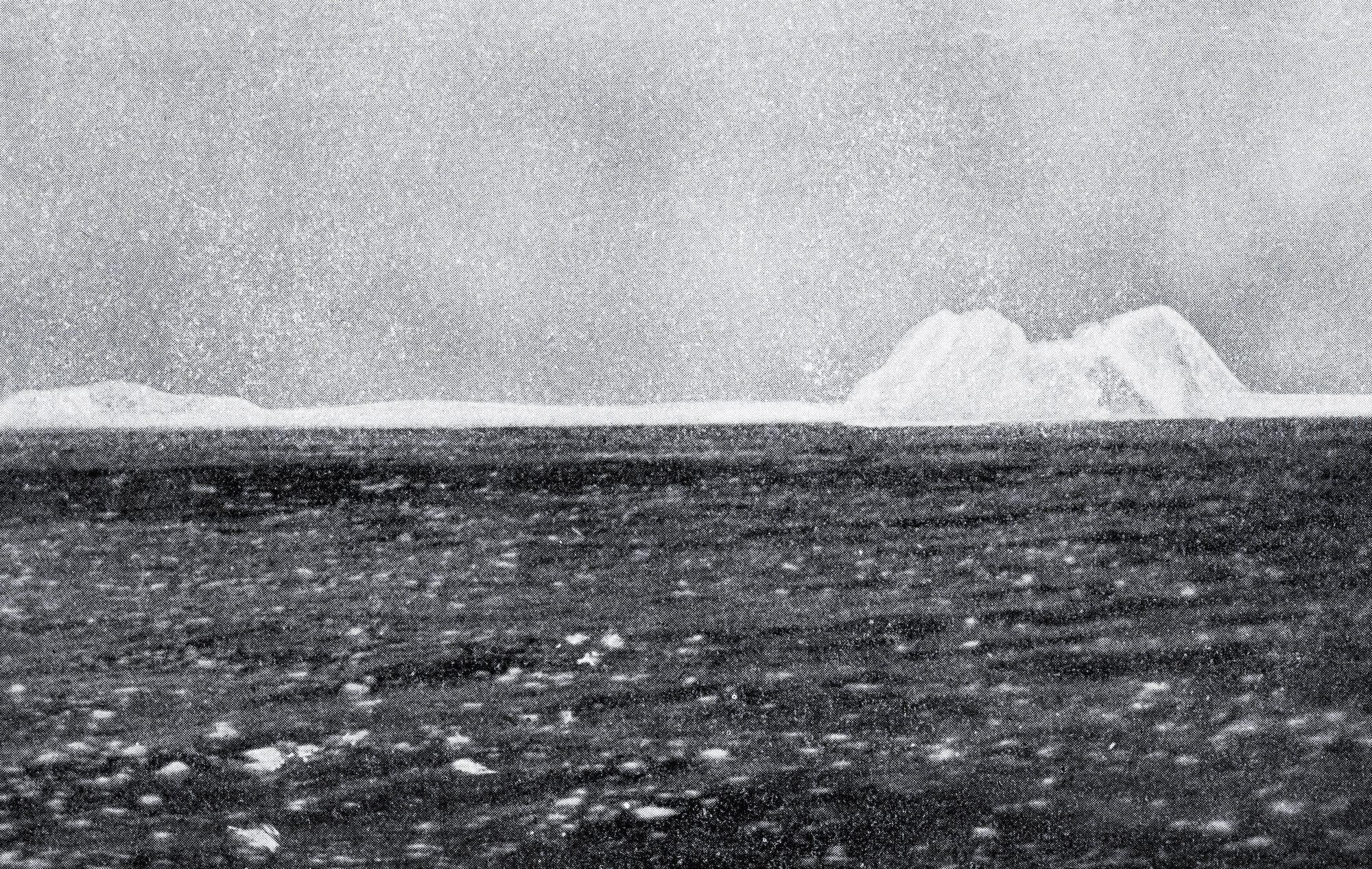 Black-and-white image of an iceberg in the distance