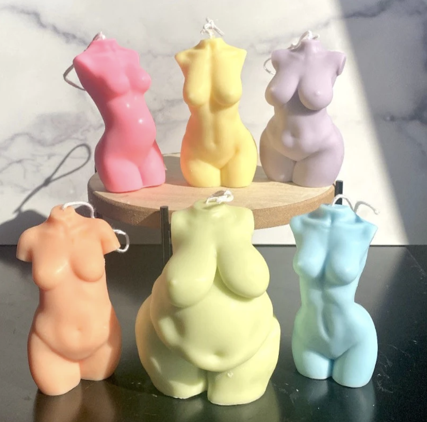 female body forms in various sizes candles in a range of colors