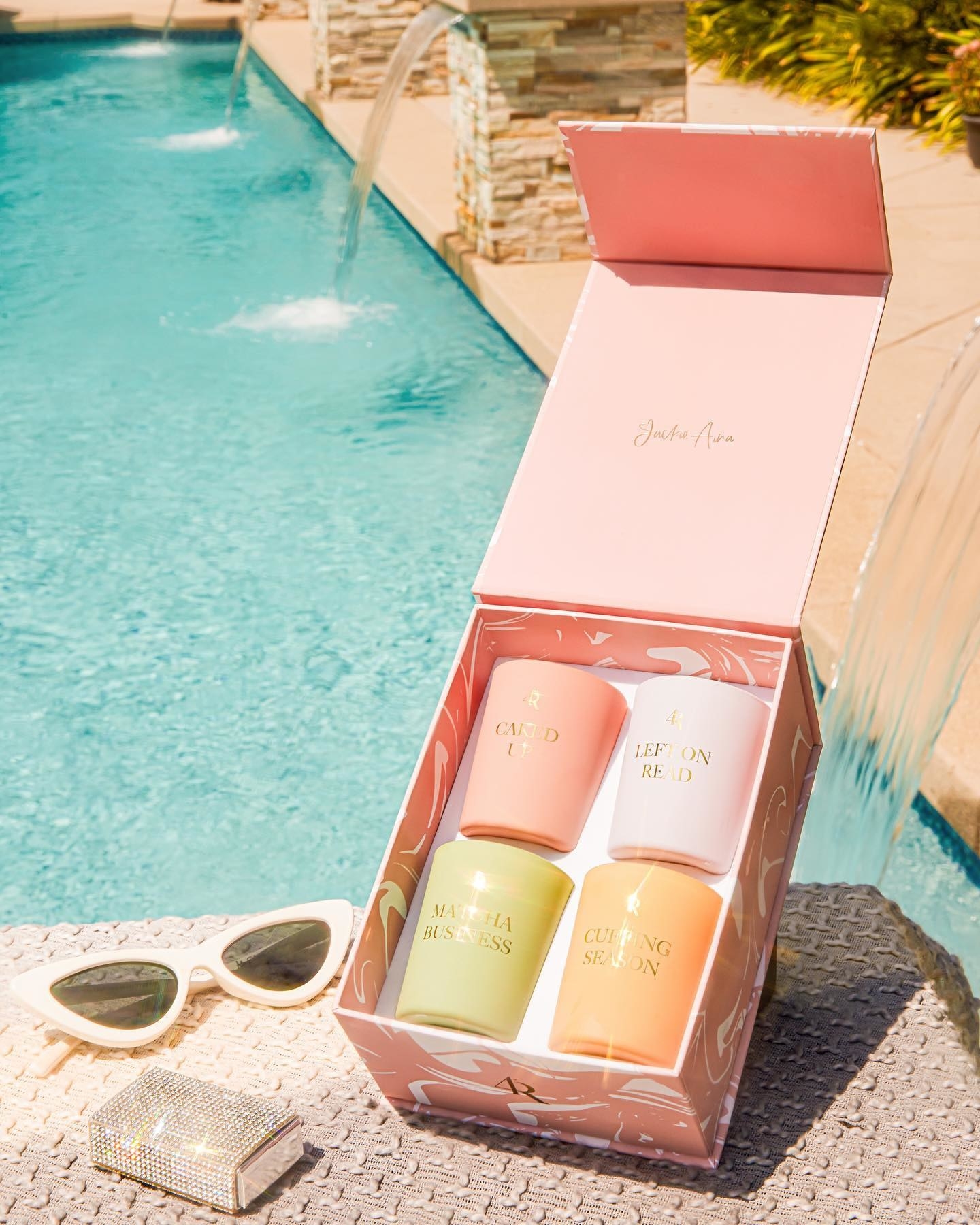 A box of candles is shown next to a pool