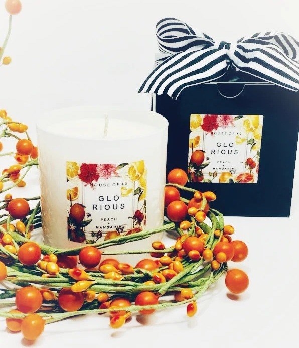 A candle and its packaging is displayed