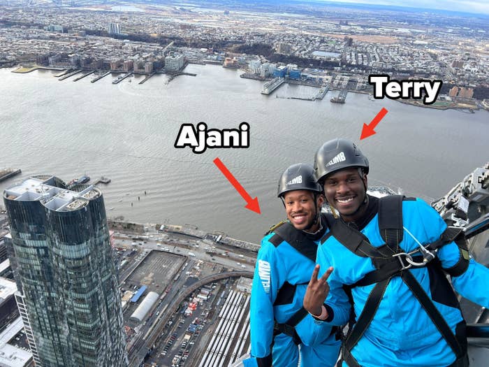 Terry and Ajani posing for a photo on the skyscraper