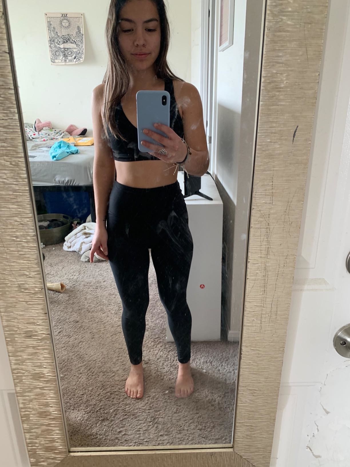 A reviewer wearing the leggings in black