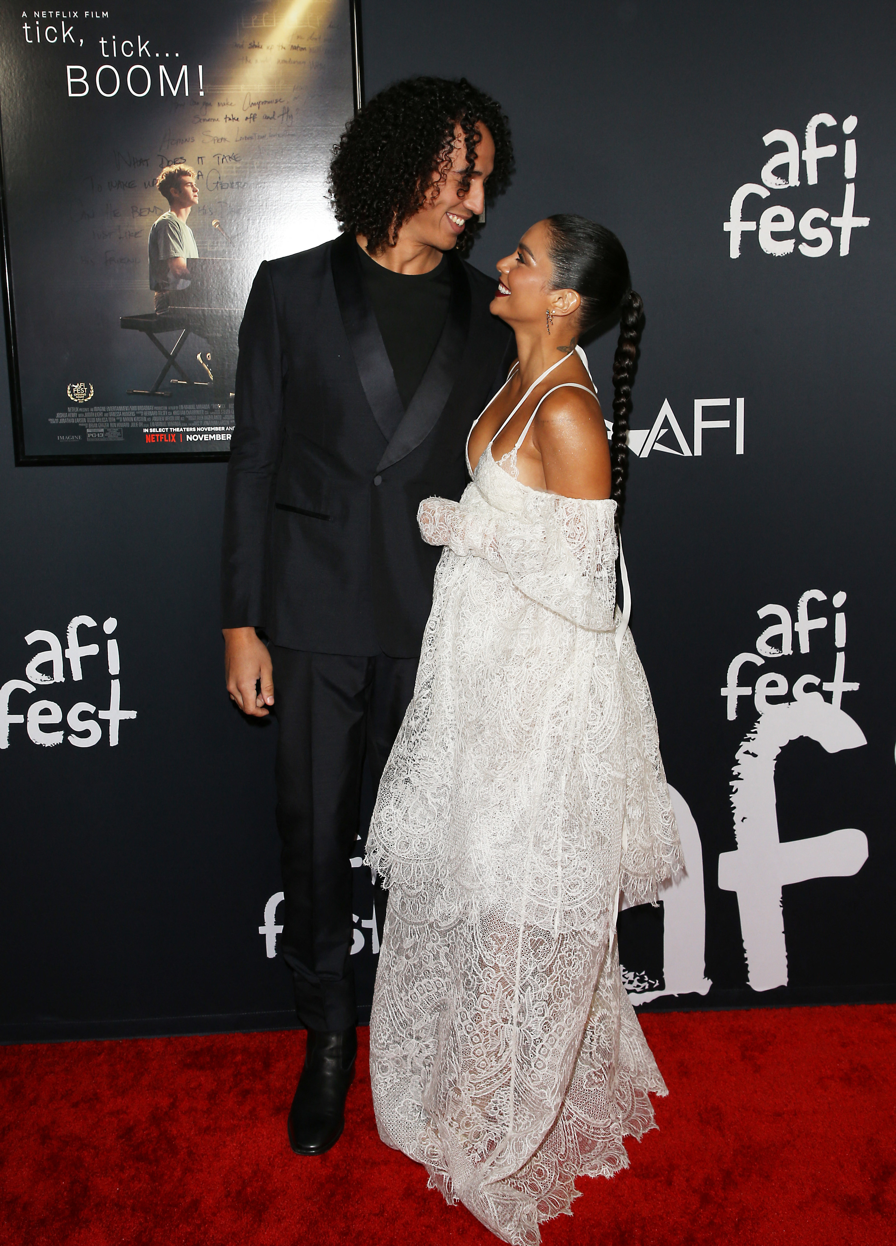 Cole and Vanessa smiling at each other on the red carpet