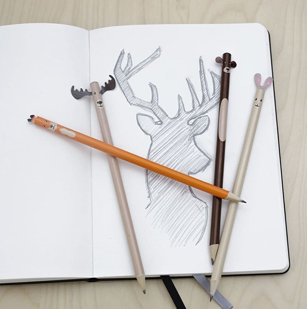 the four pencils on a notebook
