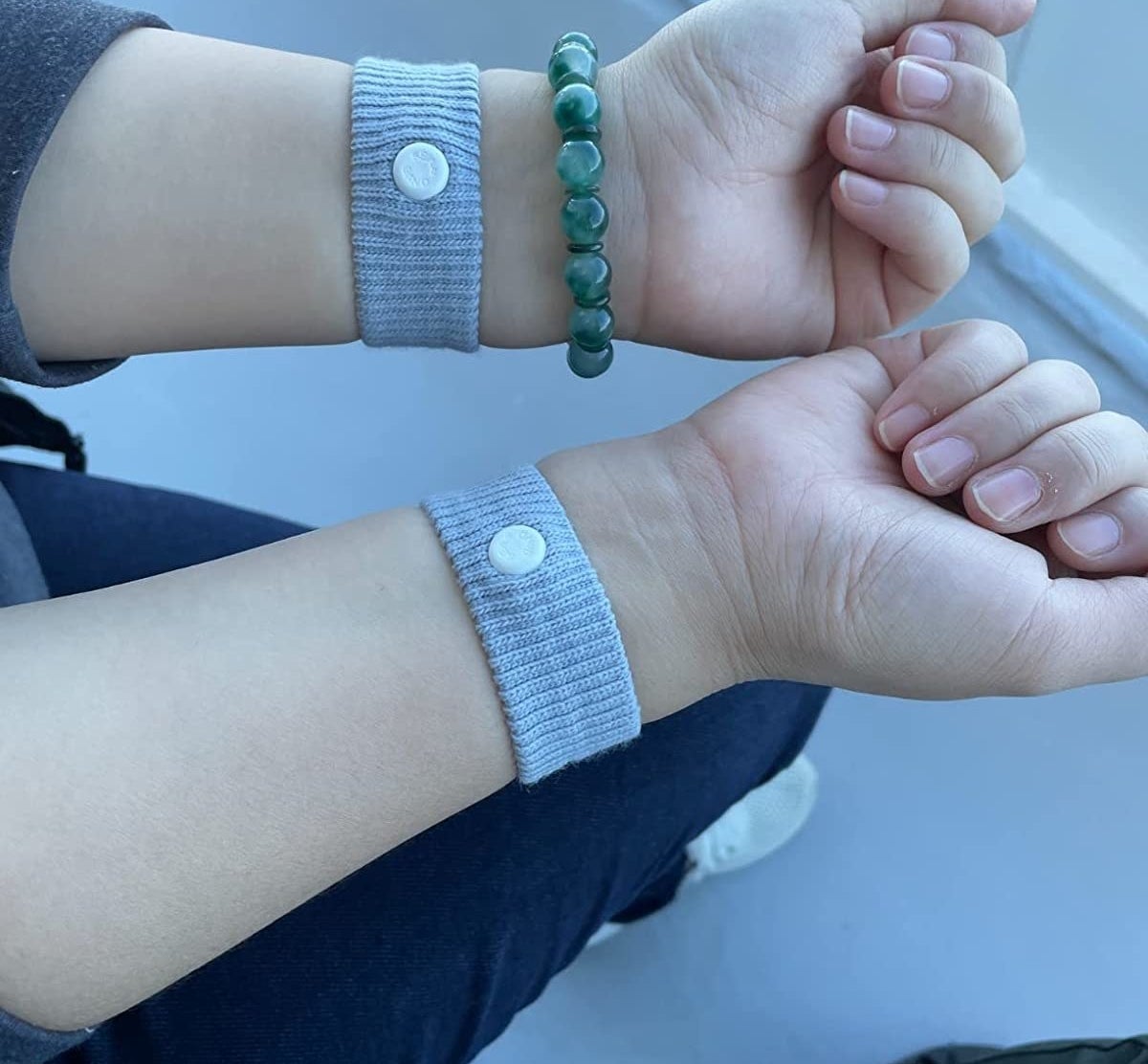 Reviewer&#x27;s photo of them wearing two Sea Bands, one on each wrist