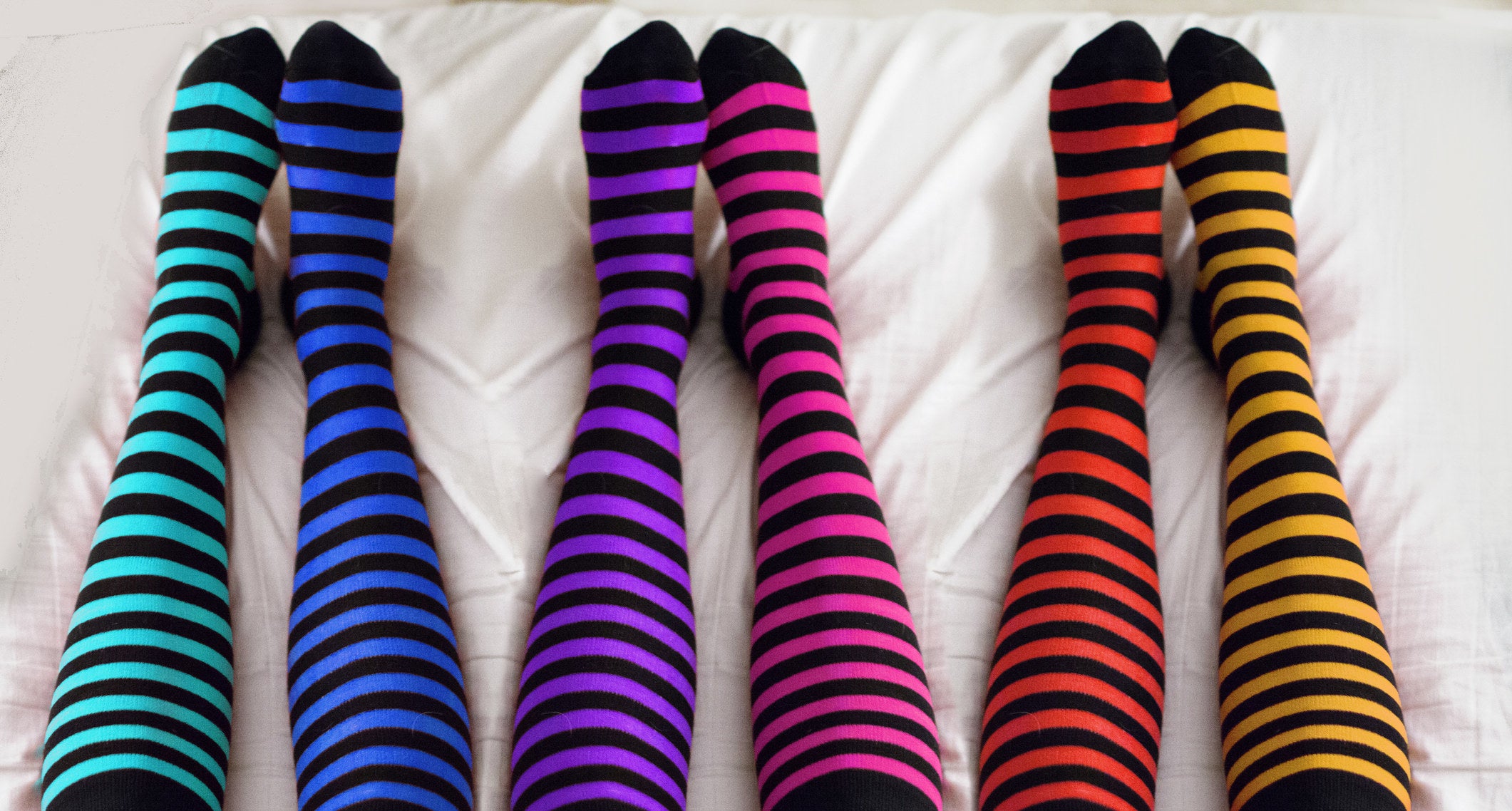 Colorful striped, mismatched knee-high socks