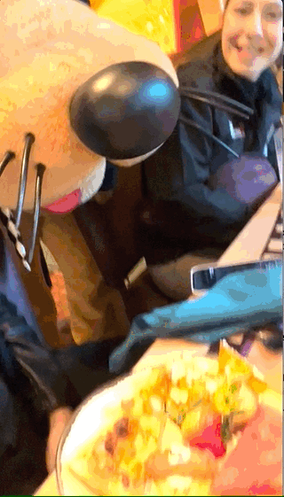 A gif of Goofy pretending to eat food at a character brunch