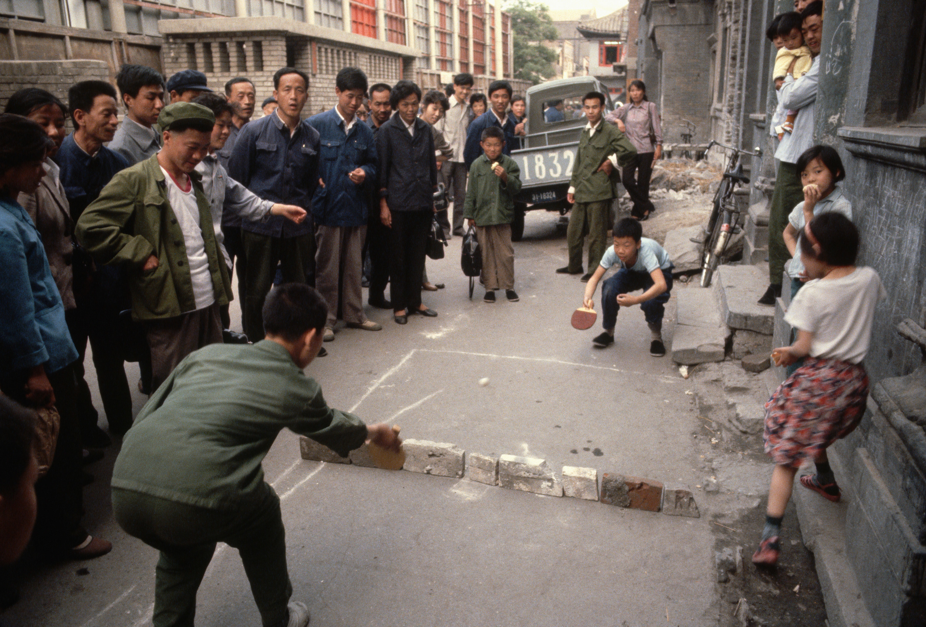 Kids play make-shift table tennis on the streets of China