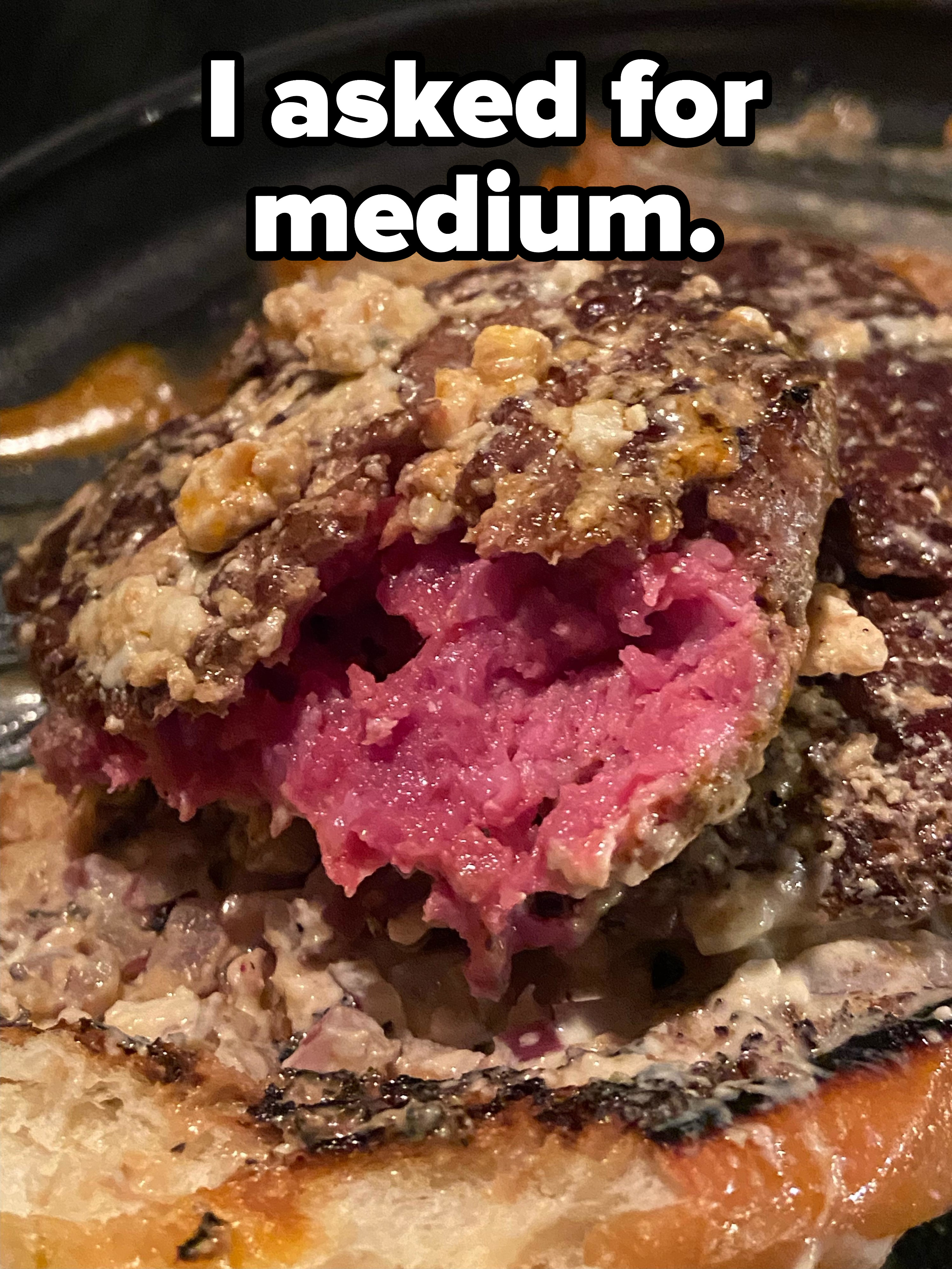 Raw burger inside a bun when person asked for medium
