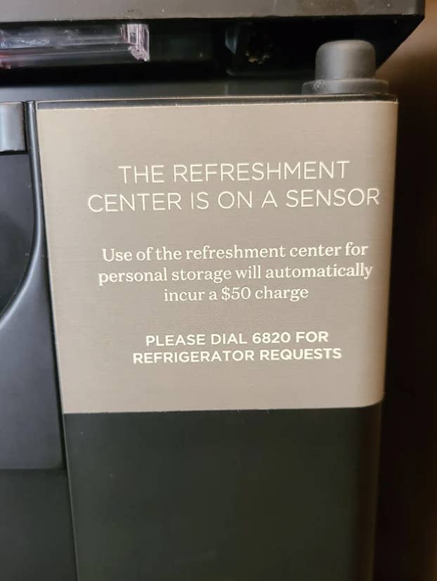 Sign saying use of refreshment center will incur a &quot;$50 charge&quot;
