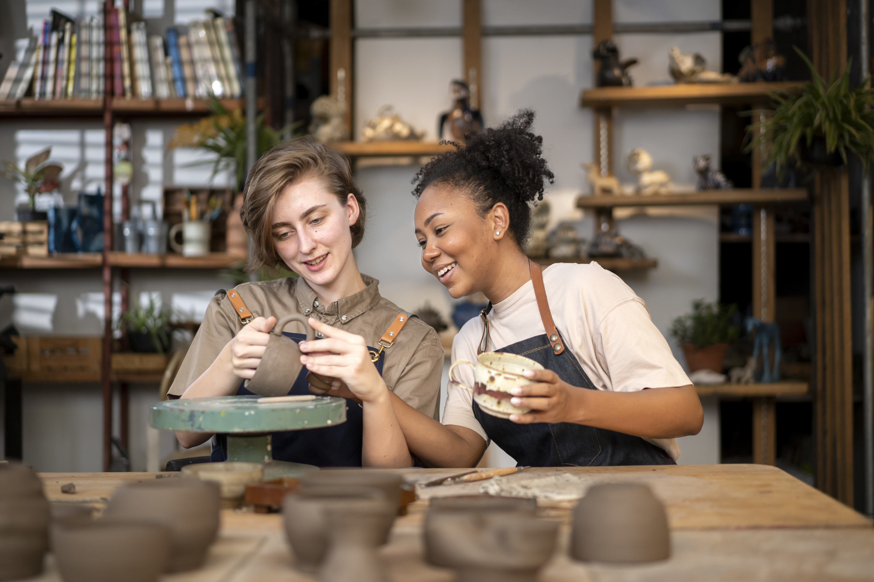 two friends making pottery together