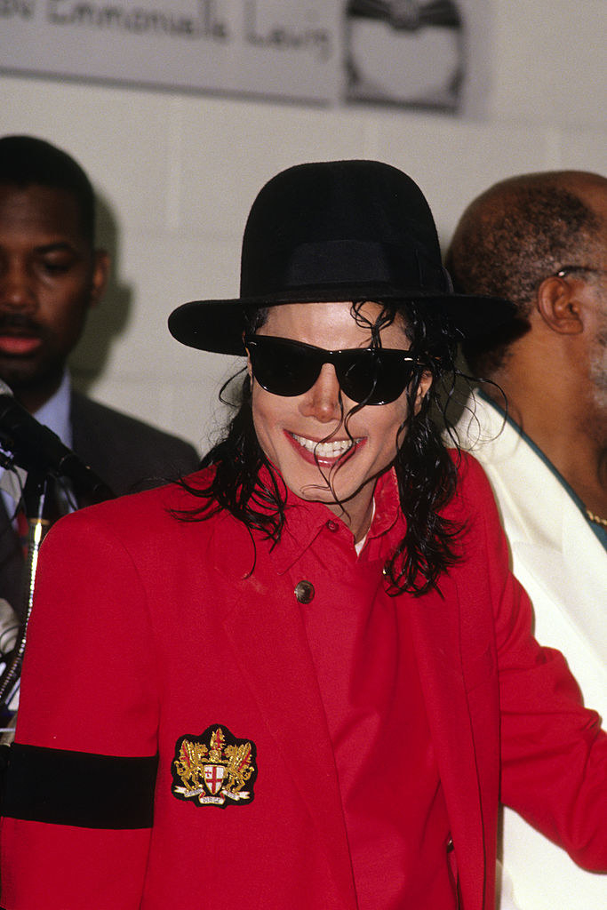 MJ in shades and a hat smiling