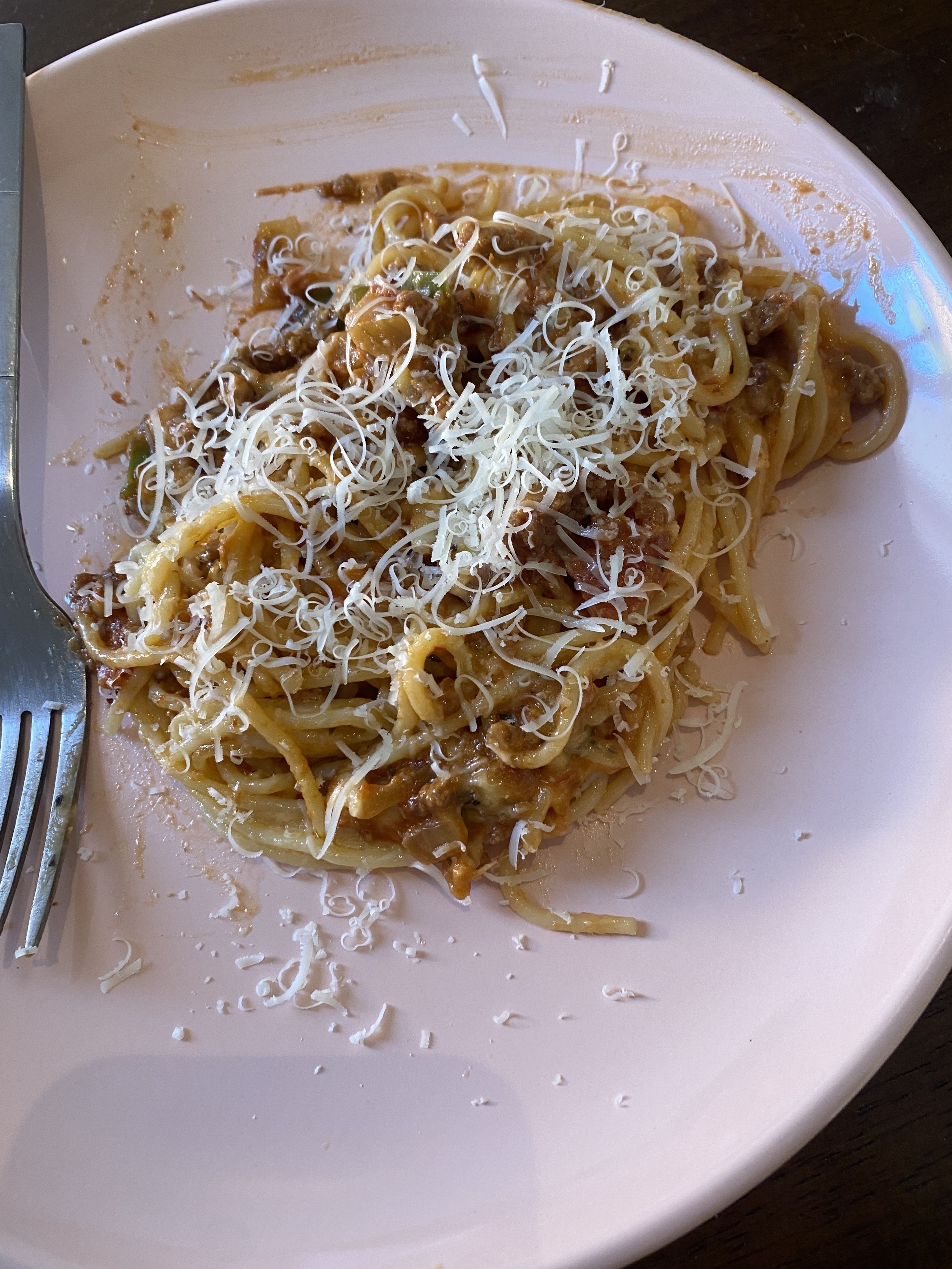 plate of the pasta with shredded cheese added