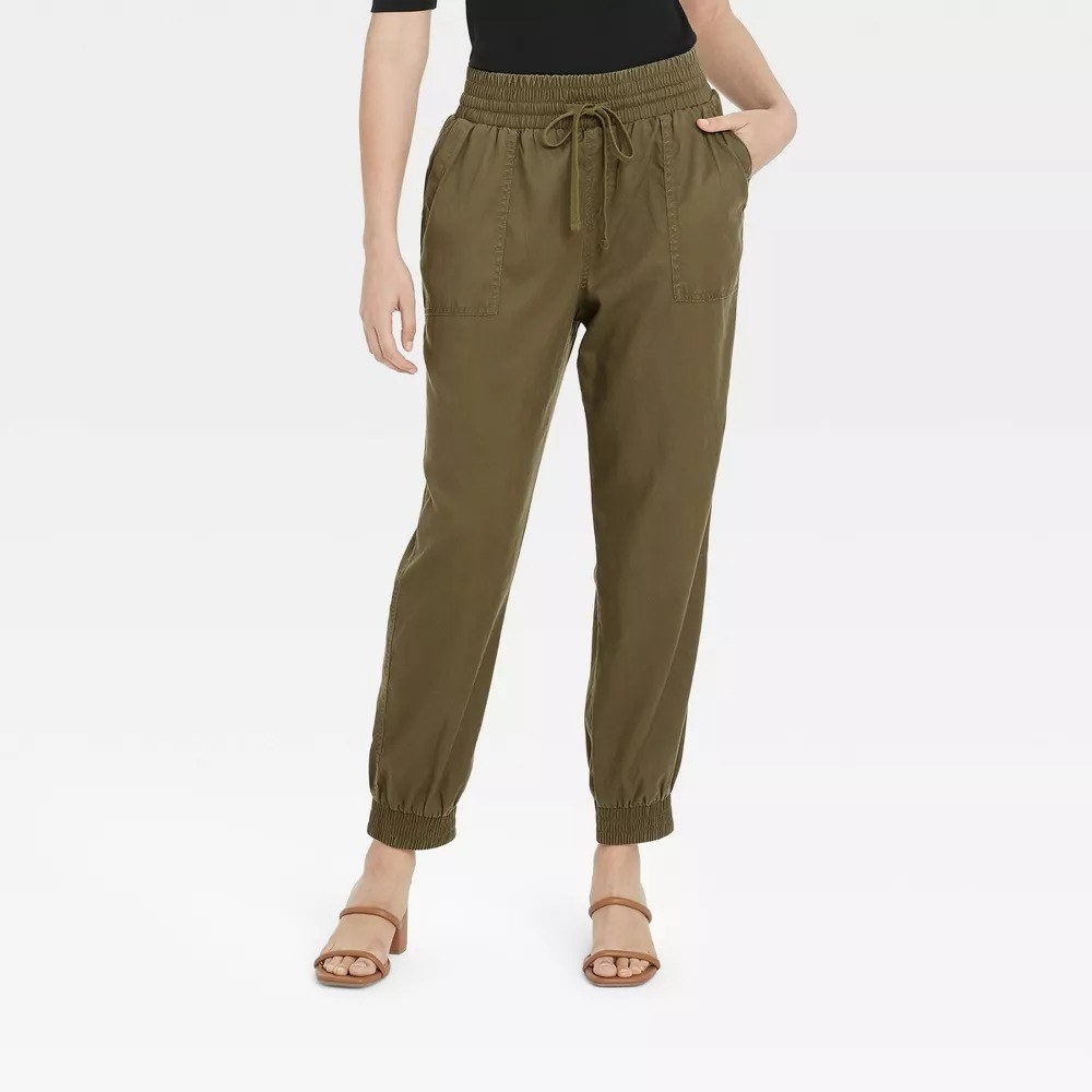a model wearing the olive green pants