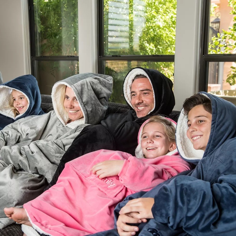 an entire family wearing comfies on a couch