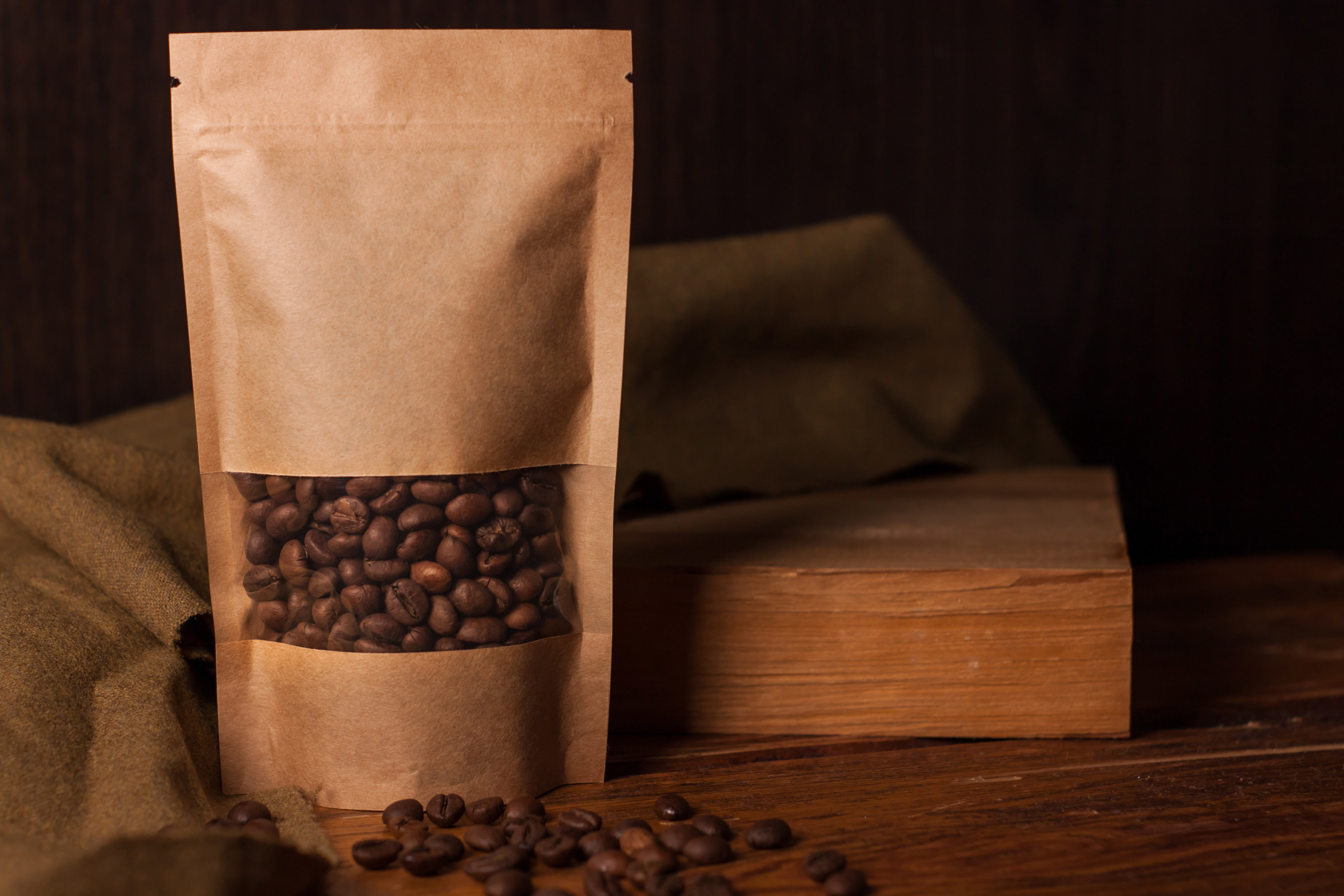 Blank brown kraft paper pouch bag with coffee beans in transparent window