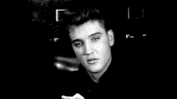 GIF of Elvis with a &#x27;50s hairdo smiling in a swivel chair