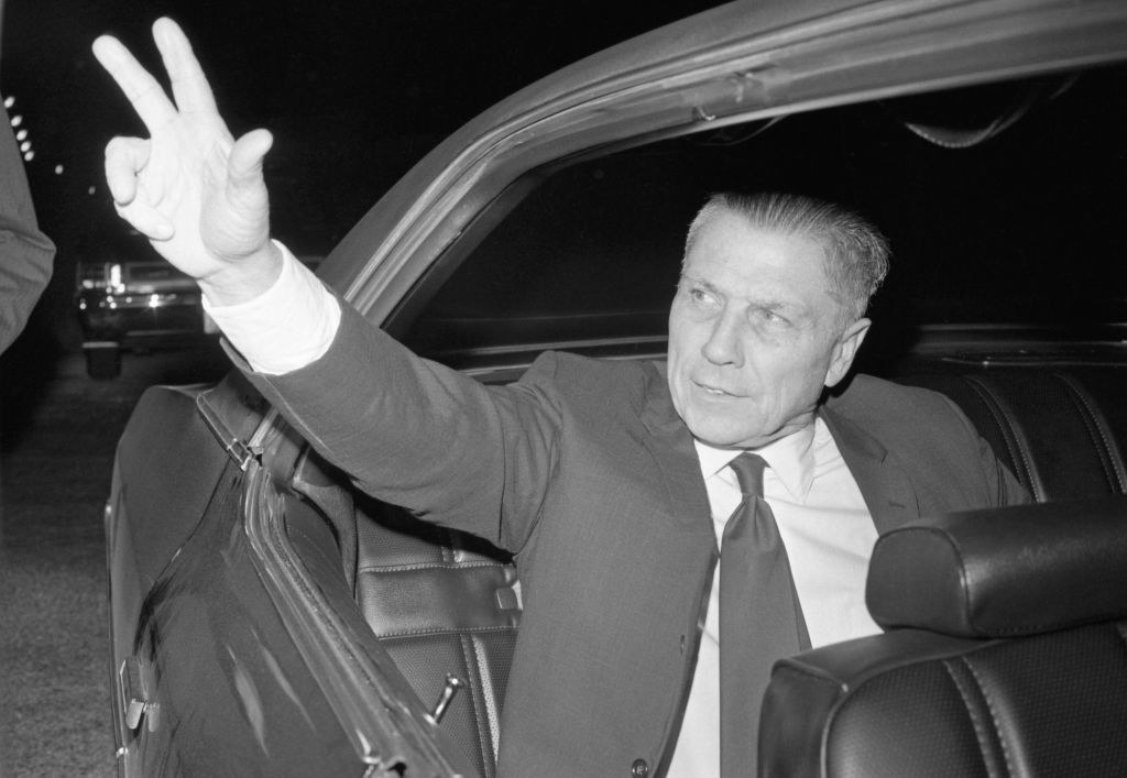 Hoffa waving to a crowd from his car