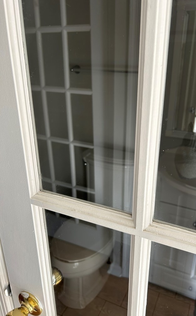 a glass door installed on a bathroom facing the toilet for minimal privacy