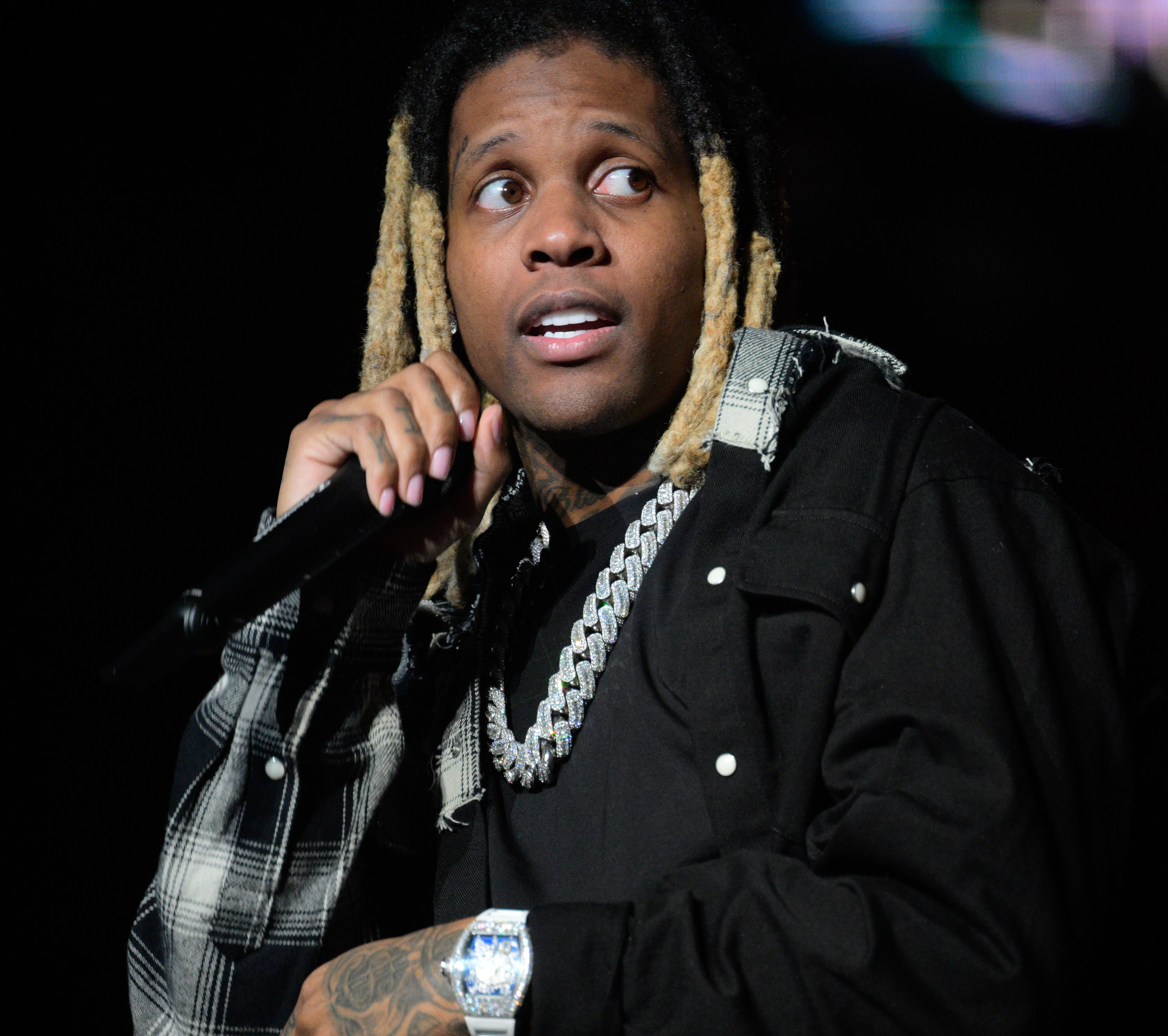 closeup of lil durk holding a mic