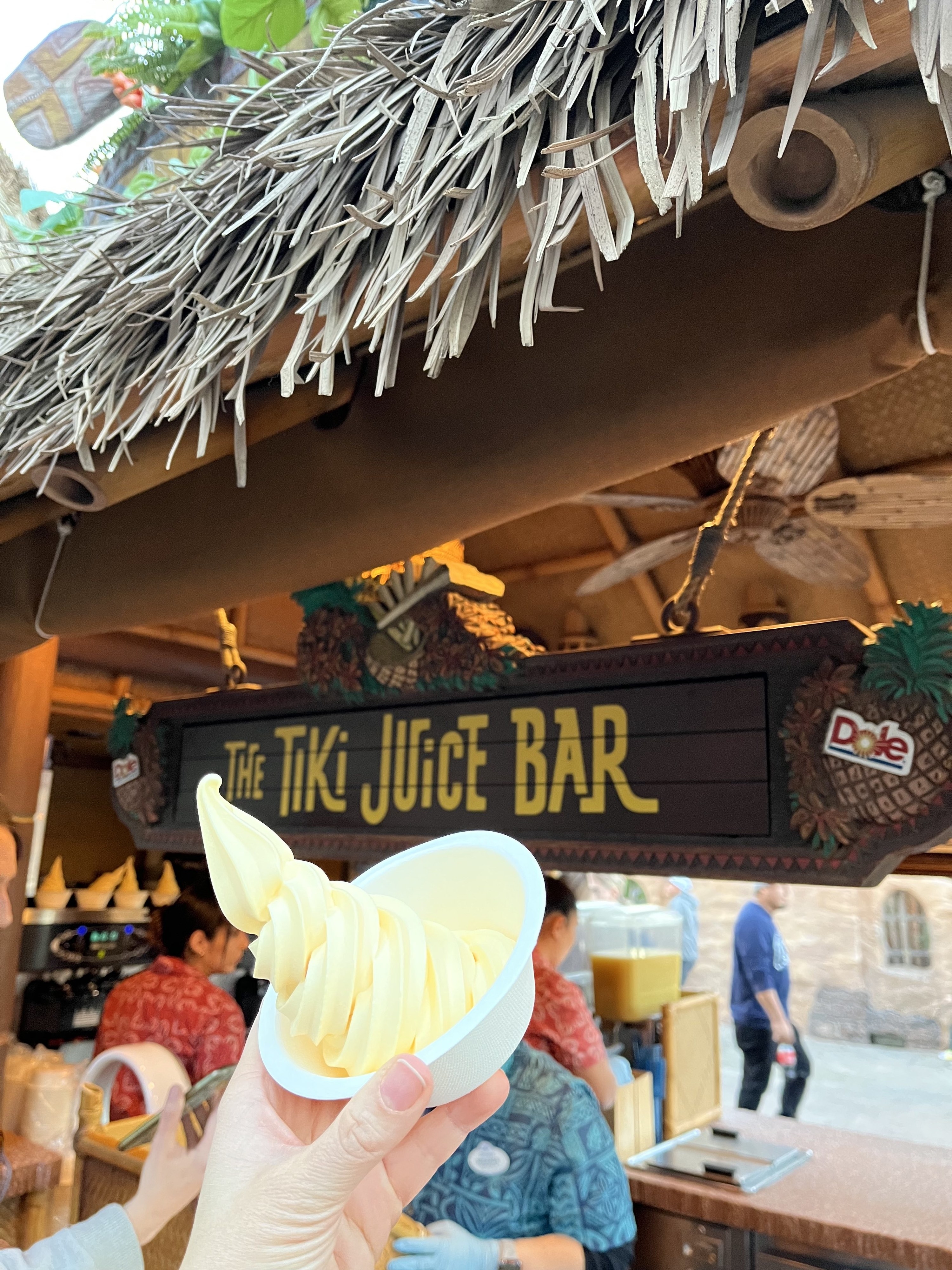 A photo of Dole Whip in front of the Tiki Juice Bar