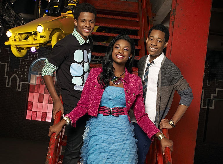 Trevor Jackson, Coco Jones, and Tyler James Williams posing on metal stairs